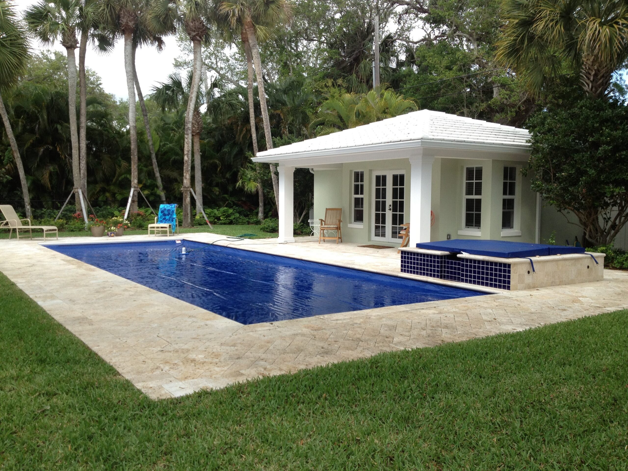 Aquamatic automatic pool cover installed on a backyard pool